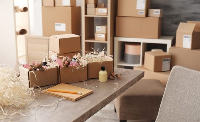 many cardbox boxes open with tissue paper and flowers inside